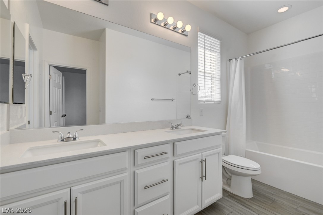 756 Cadence View Way Henderson, NV 89011 - Photo 31 of 45 Bathroom with double vanity, shower / bath combo, and light wood-style floors