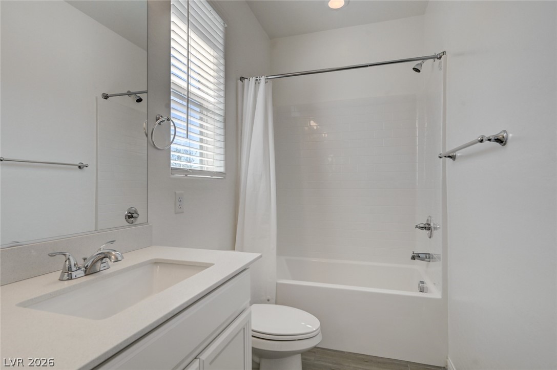 756 Cadence View Way Henderson, NV 89011 - Photo 32 of 45 Bathroom featuring vanity, shower / tub combo, and light wood-type flooring