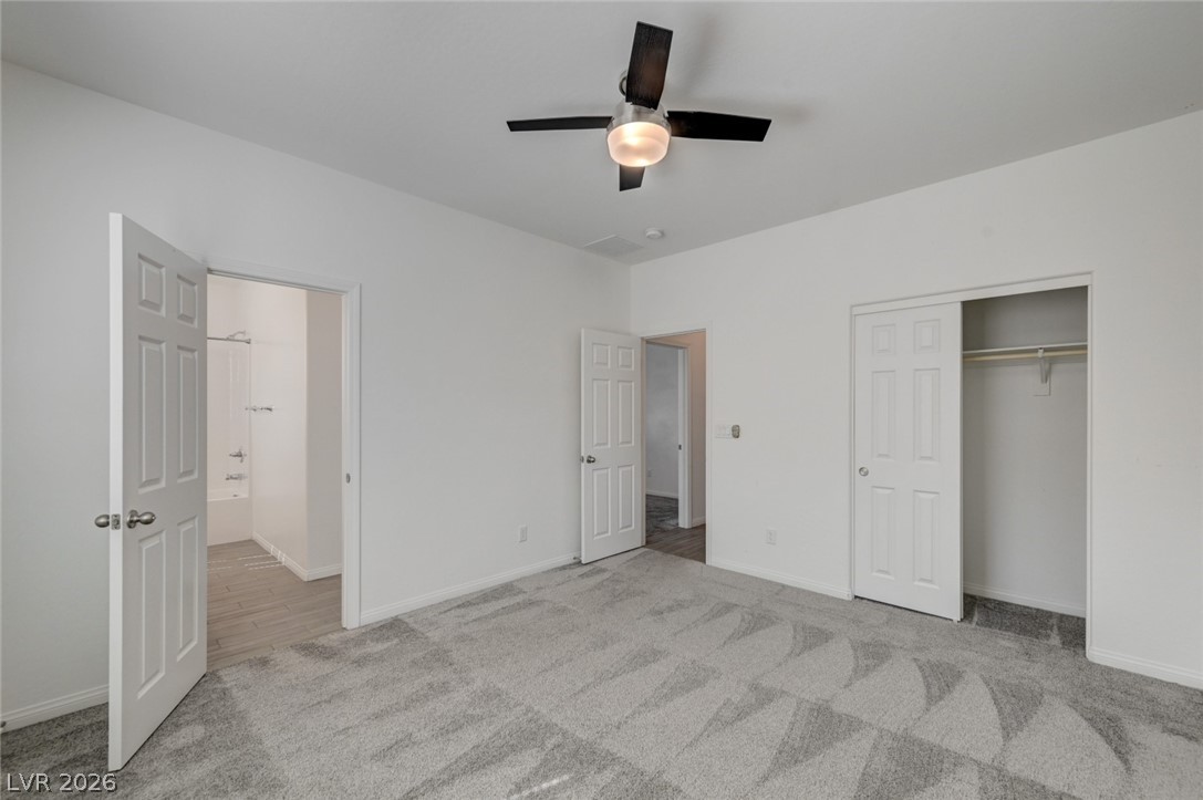 756 Cadence View Way Henderson, NV 89011 - Photo 35 of 45 Unfurnished bedroom featuring a ceiling fan, light carpet, and a closet