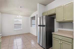 2721 Breezy Point Cove Round Rock, TX 78665 - Photo 12 of 35 a kitchen with a refrigerator and a sink