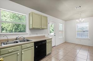 2721 Breezy Point Cove Round Rock, TX 78665 - Photo 13 of 35 a kitchen with a sink window and cabinets