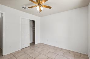 2721 Breezy Point Cove Round Rock, TX 78665 - Photo 15 of 35 an empty room with a chandelier fan and glass door