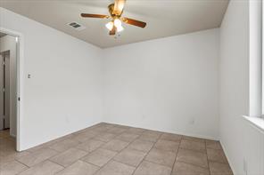 2721 Breezy Point Cove Round Rock, TX 78665 - Photo 21 of 35 an empty room with windows and chandelier fan