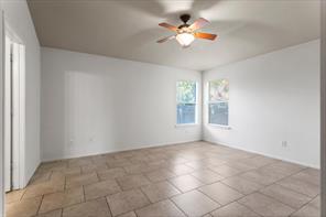 2721 Breezy Point Cove Round Rock, TX 78665 - Photo 22 of 35 an empty room with windows and chandelier fan