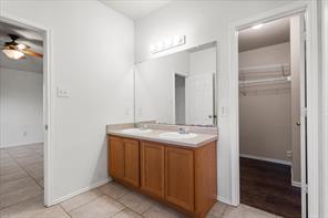 2721 Breezy Point Cove Round Rock, TX 78665 - Photo 26 of 35 a bathroom with a granite countertop sink and a mirror