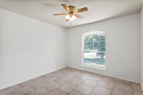 2721 Breezy Point Cove Round Rock, TX 78665 - Photo 29 of 35 an empty room with windows and chandelier fan