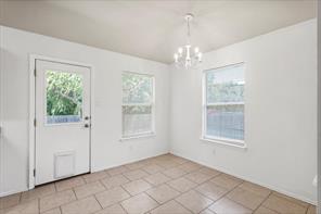 2721 Breezy Point Cove Round Rock, TX 78665 - Photo 7 of 35 an empty room with chandelier and windows