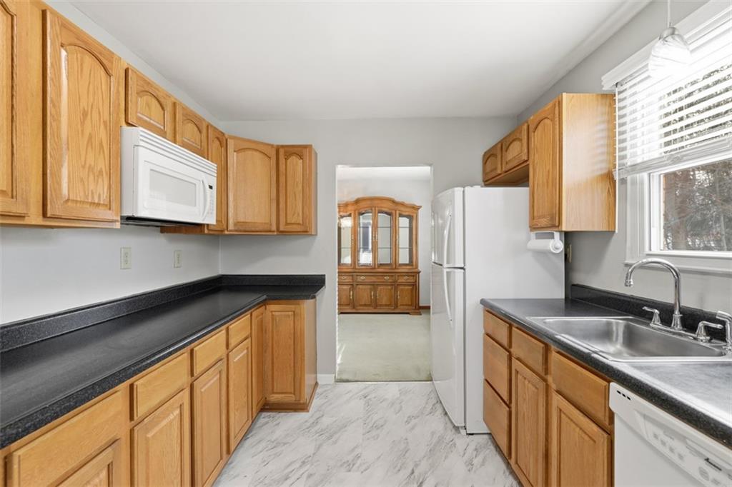 27 Ehle Avenue Coraopolis, PA 15108 - Photo 15 of 44 a kitchen with stainless steel appliances granite countertop a sink a stove and a refrigerator