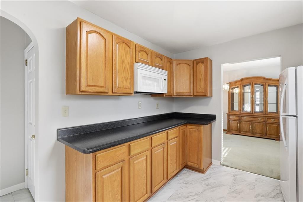27 Ehle Avenue Coraopolis, PA 15108 - Photo 16 of 44 a kitchen with stainless steel appliances granite countertop a stove a sink and a microwave