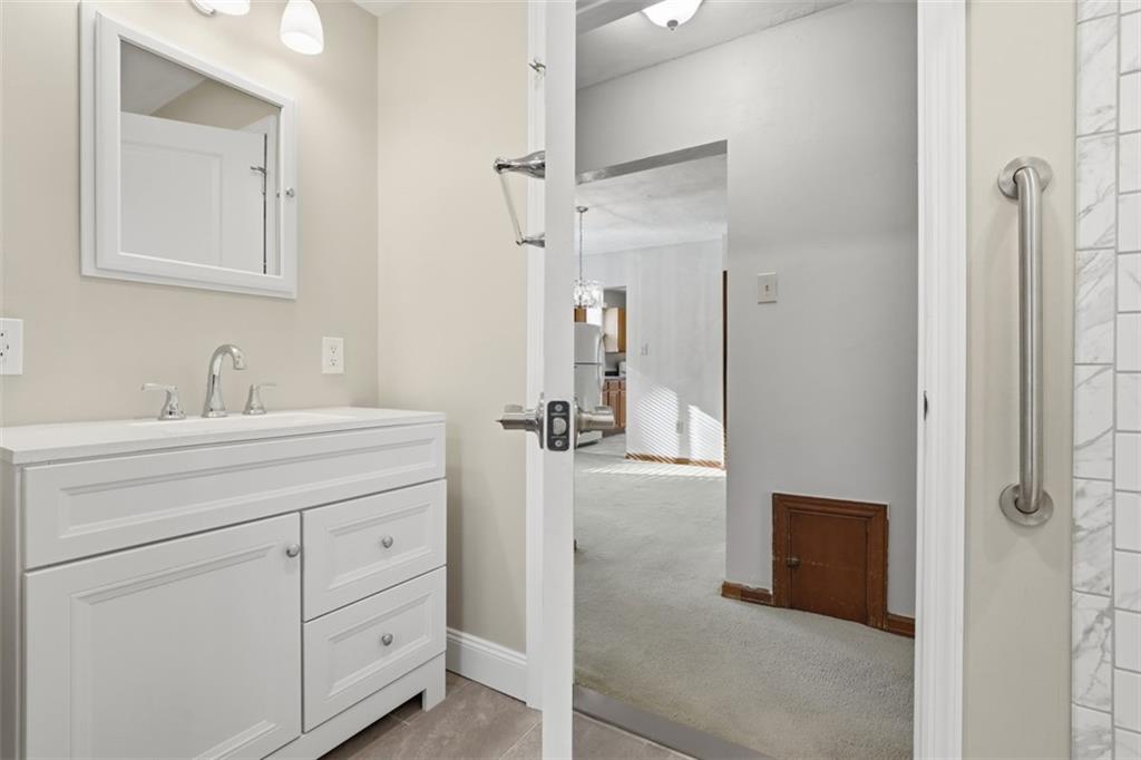 27 Ehle Avenue Coraopolis, PA 15108 - Photo 24 of 44 a bathroom with a shower sink and mirror