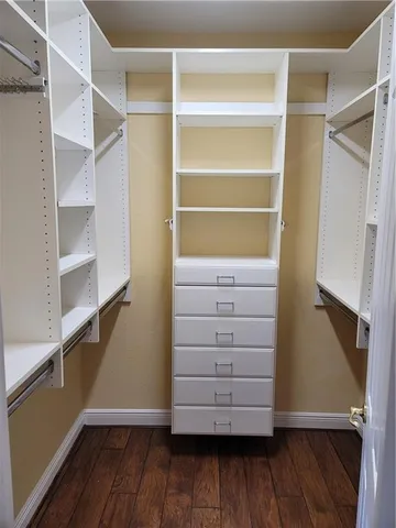 a view of walk in closet with empty racks