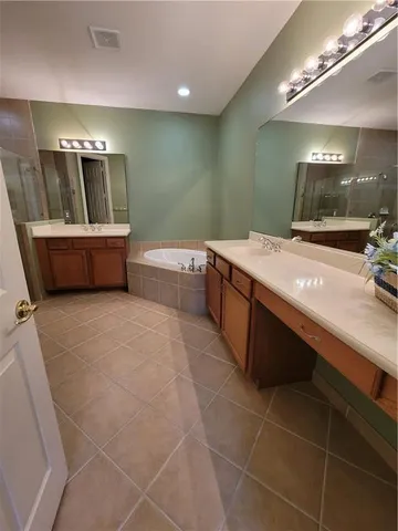 a large bathroom with a large tub and sink