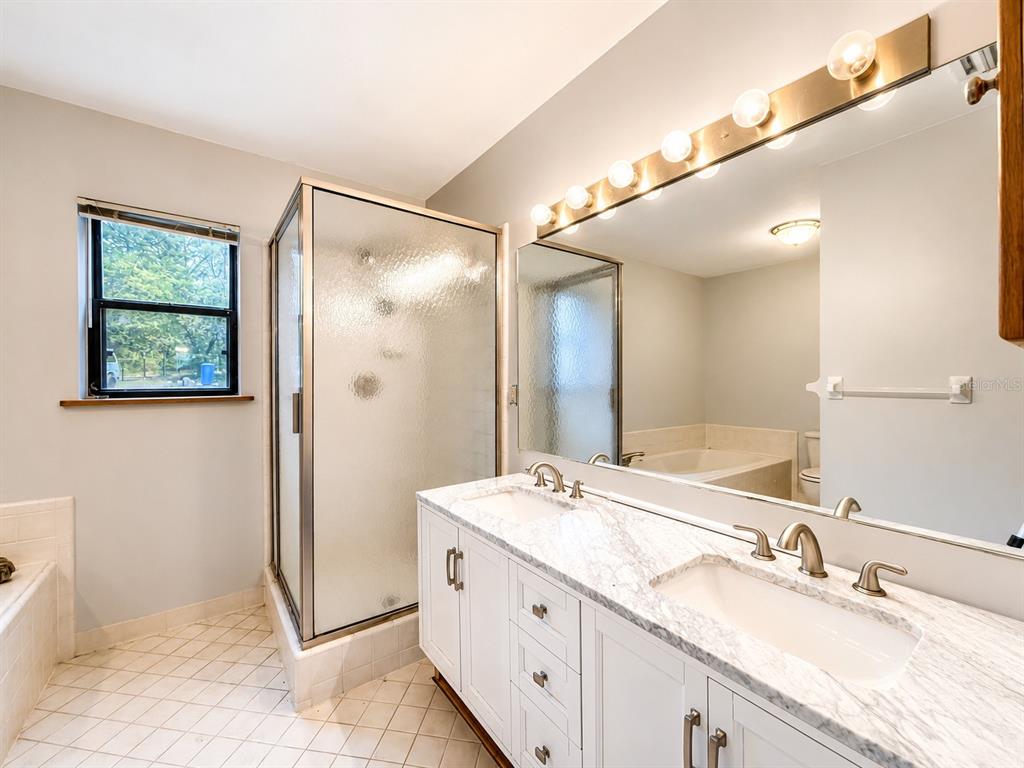 7119 Immokalee Road Keystone Heights, FL 32656 - Photo 20 of 50 a bathroom with a granite countertop sink mirror and double