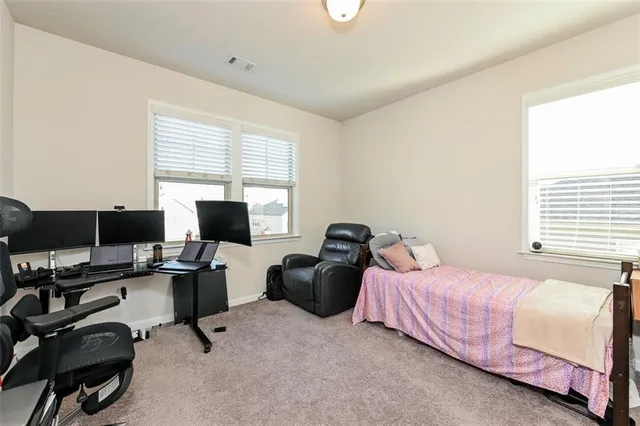 a bedroom with a workspace