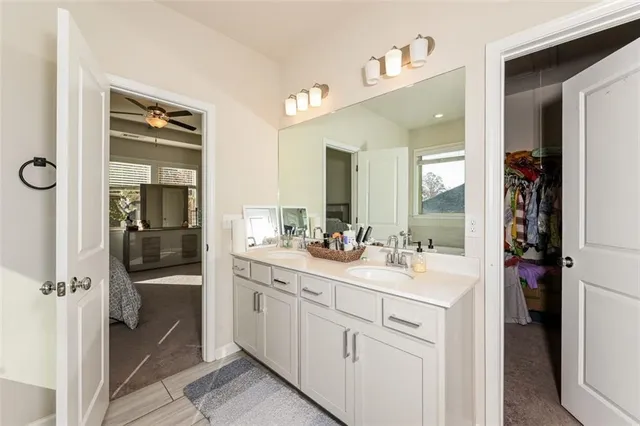a bathroom with a double vanity sink a mirror and a shower