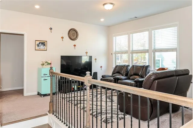 a living room with furniture tv and a window