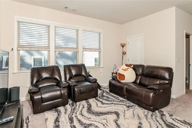 a bedroom with furniture and a large window