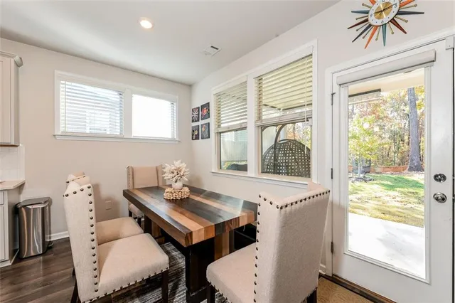 a view of a dining room with furniture a chandelier and wooden floor