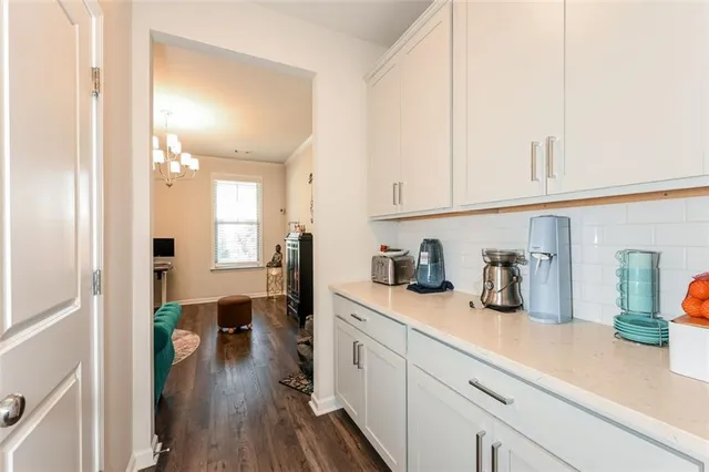 a kitchen with cabinets and wooden floor