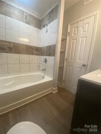 a bathroom with a bathtub and a shower