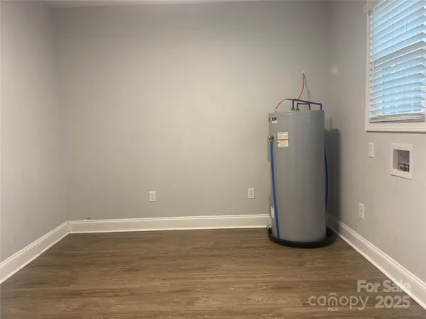 a view of a room with wooden floor and cabinet