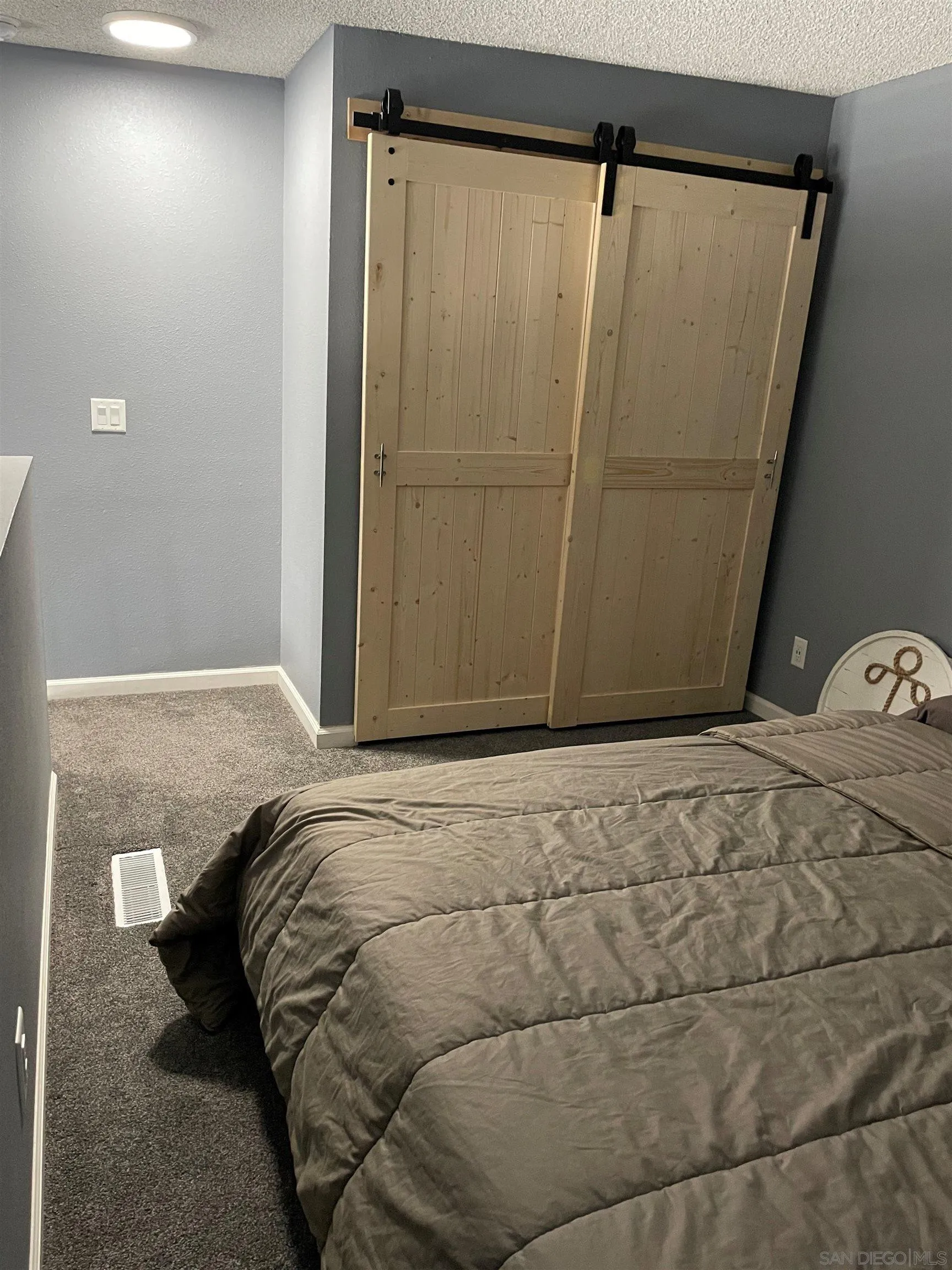 6131 Rancho Mission Road, Unit 323 San Diego, CA 92108 - Photo 8 of 11 a bedroom with a bed and a shower