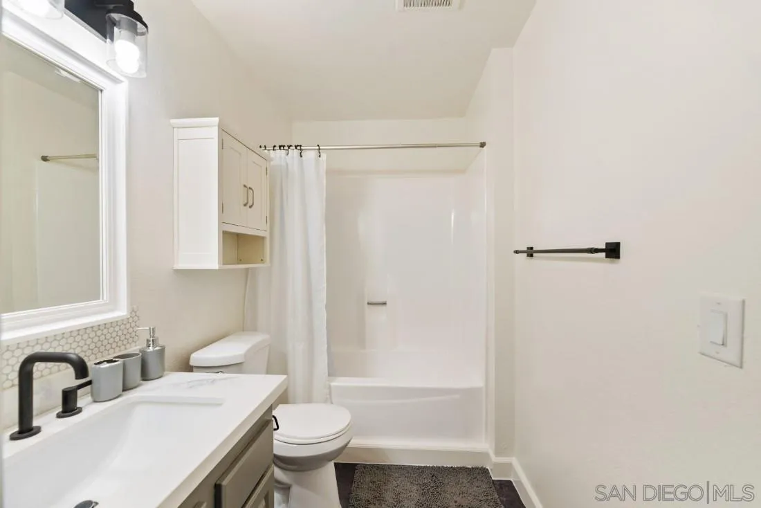 6131 Rancho Mission Road, Unit 323 San Diego, CA 92108 - Photo 9 of 11 a bathroom with a sink toilet and shower
