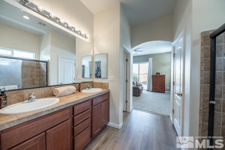 385 Manciano Way Reno, NV 89521 - Photo 15 of 30 a spacious bathroom with a double vanity sink and a mirror