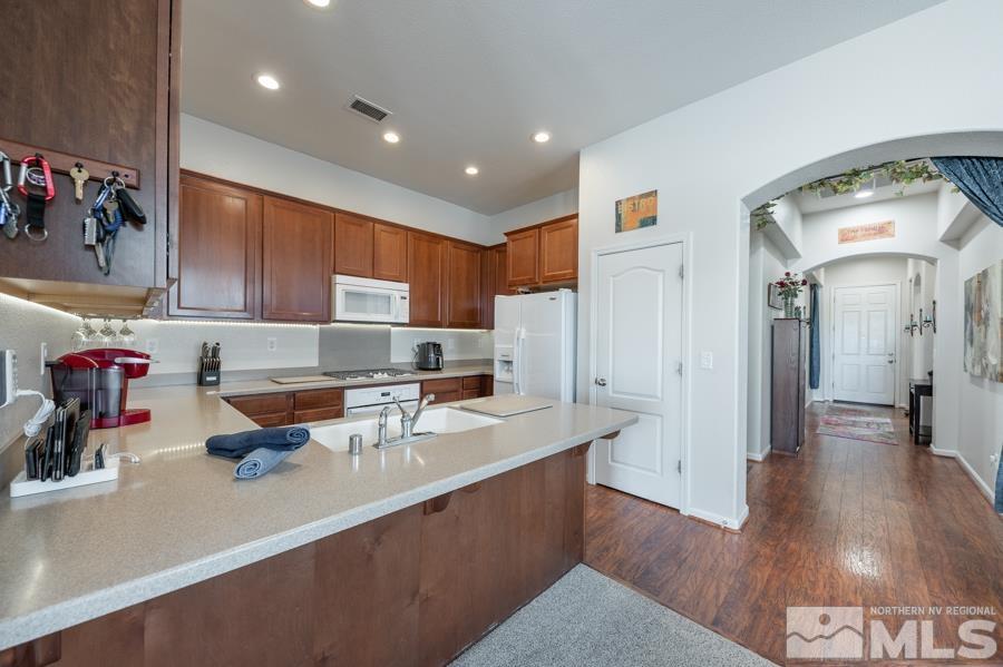 385 Manciano Way Reno, NV 89521 - Photo 6 of 30 a kitchen with a sink a refrigerator and wooden floor