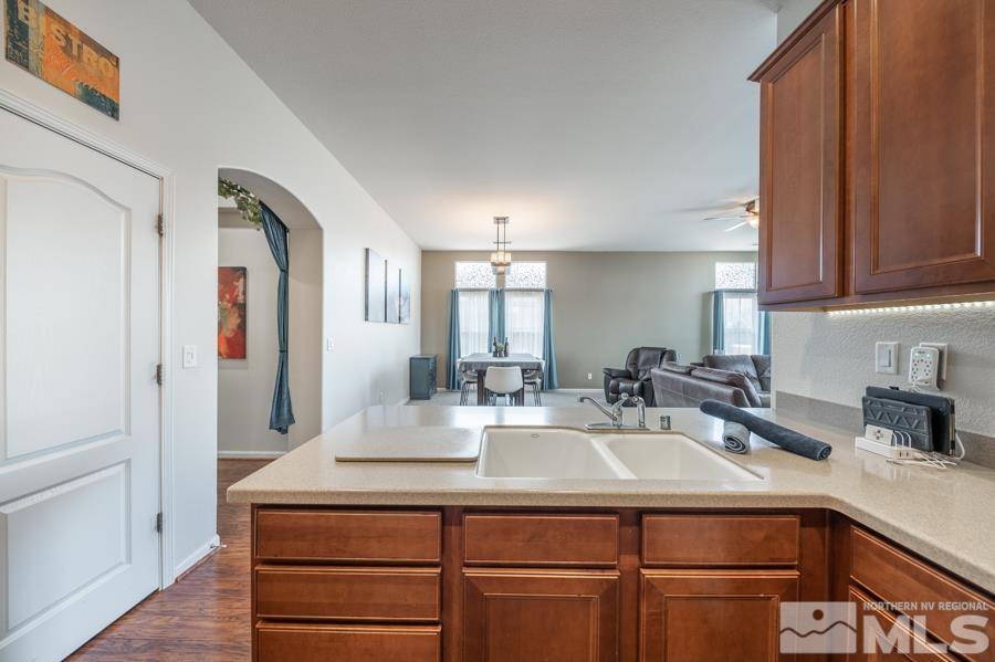 385 Manciano Way Reno, NV 89521 - Photo 8 of 30 a kitchen with a sink cabinets and a wooden floor