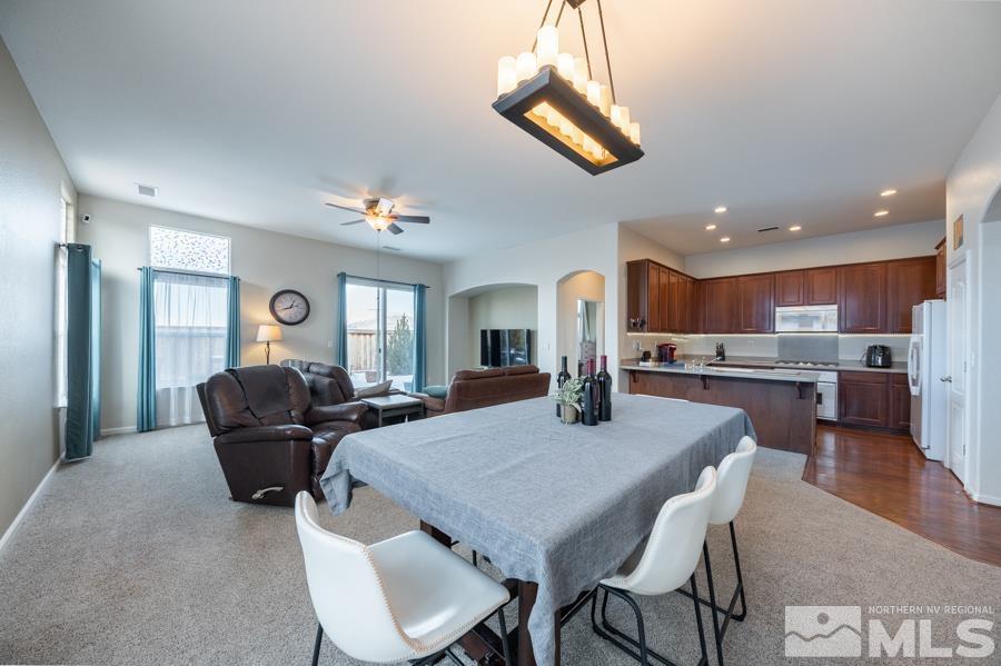 385 Manciano Way Reno, NV 89521 - Photo 10 of 30 a view of a dining room with furniture and a chandelier