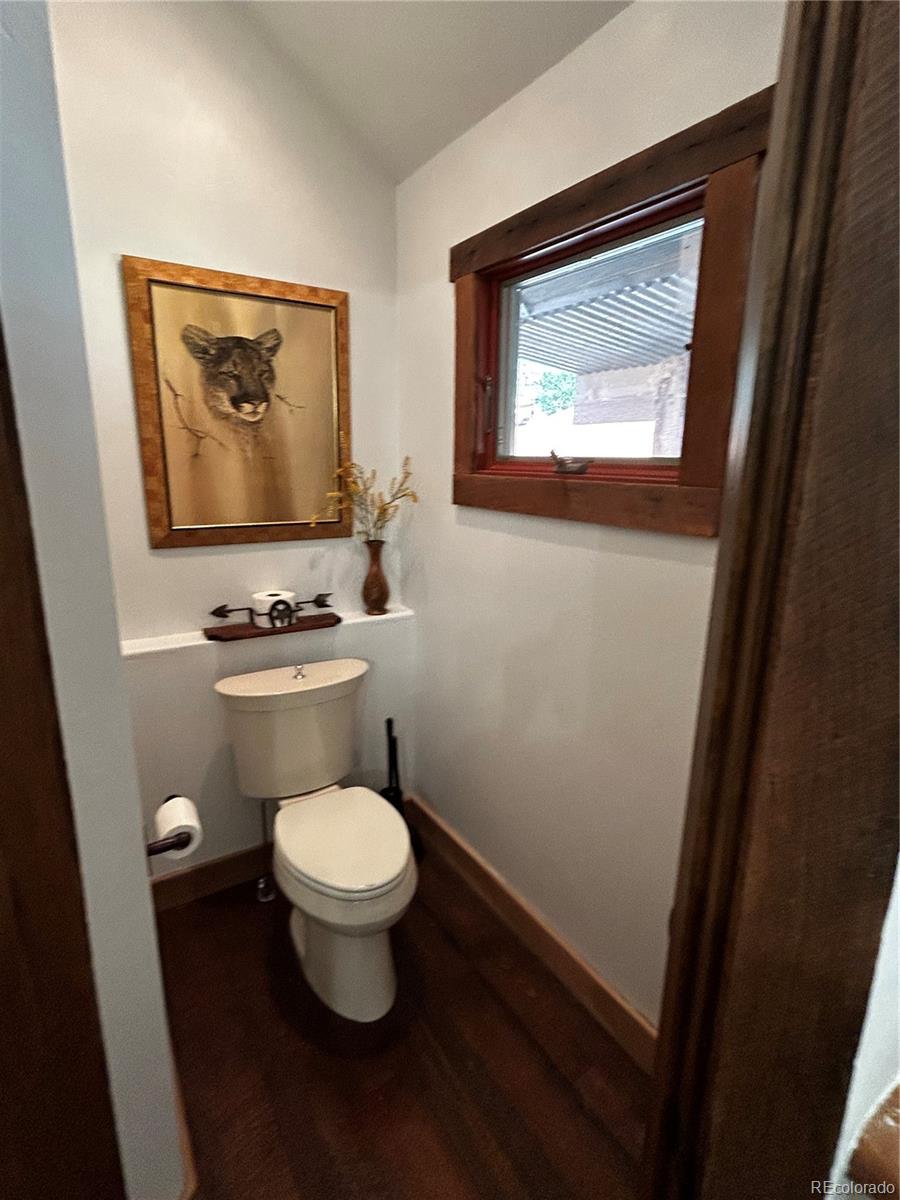 8238 Old San Isabel Road Rye, CO 81069 - Photo 11 of 31 a bathroom with a toilet a sink and a window