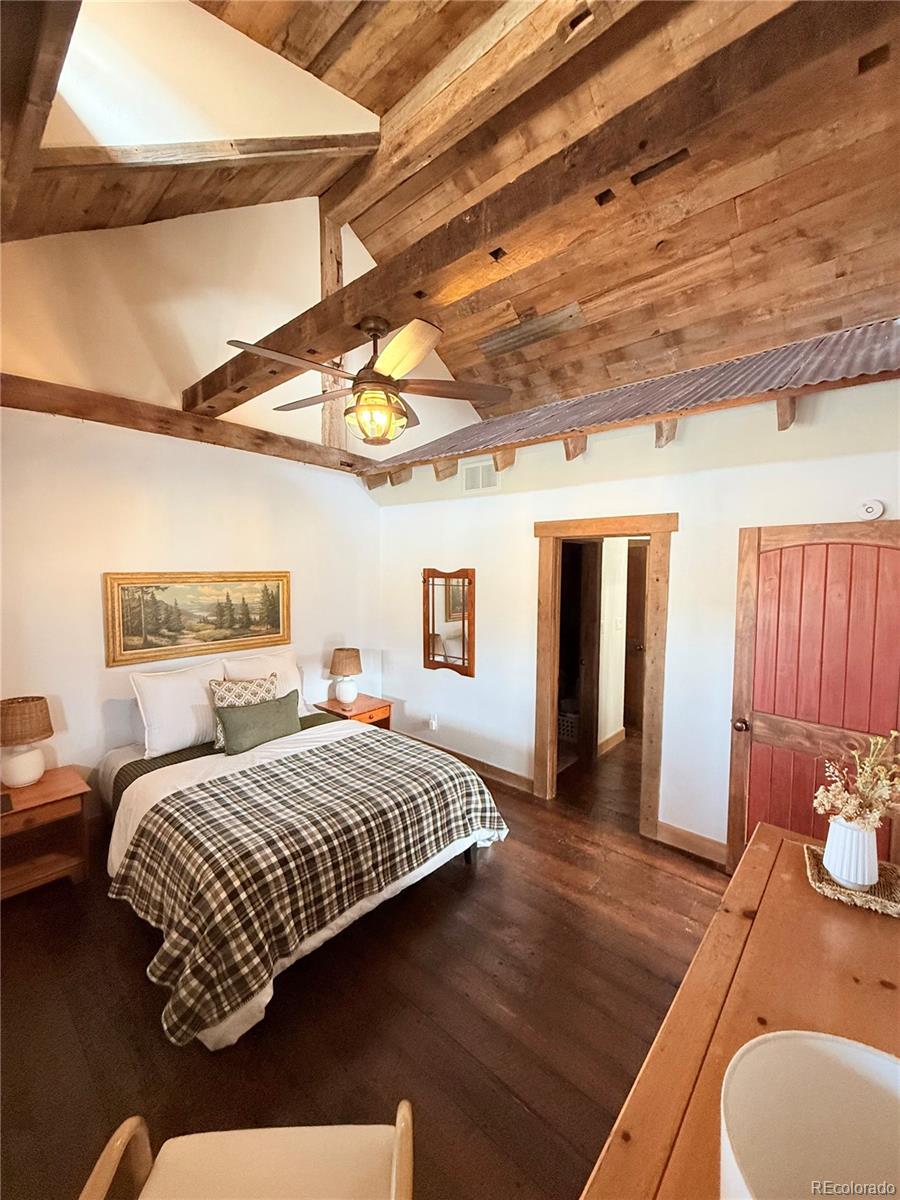 8238 Old San Isabel Road Rye, CO 81069 - Photo 14 of 31 a bedroom with a bed and wooden floor