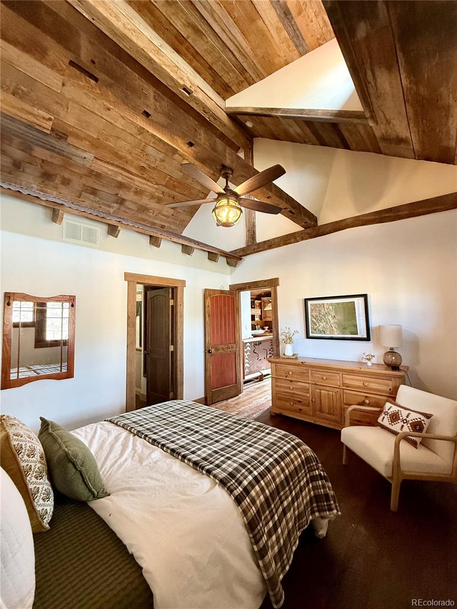 8238 Old San Isabel Road Rye, CO 81069 - Photo 15 of 31 a bedroom with bed and wooden floor
