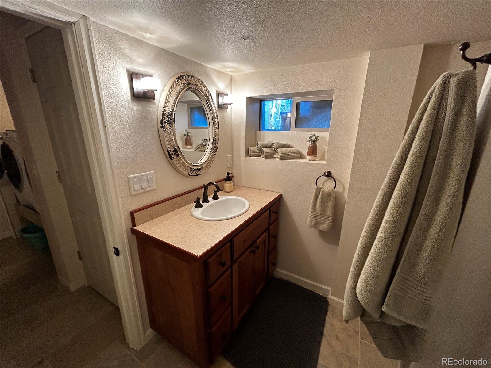 8238 Old San Isabel Road Rye, CO 81069 - Photo 16 of 31 a bathroom with a sink and a mirror