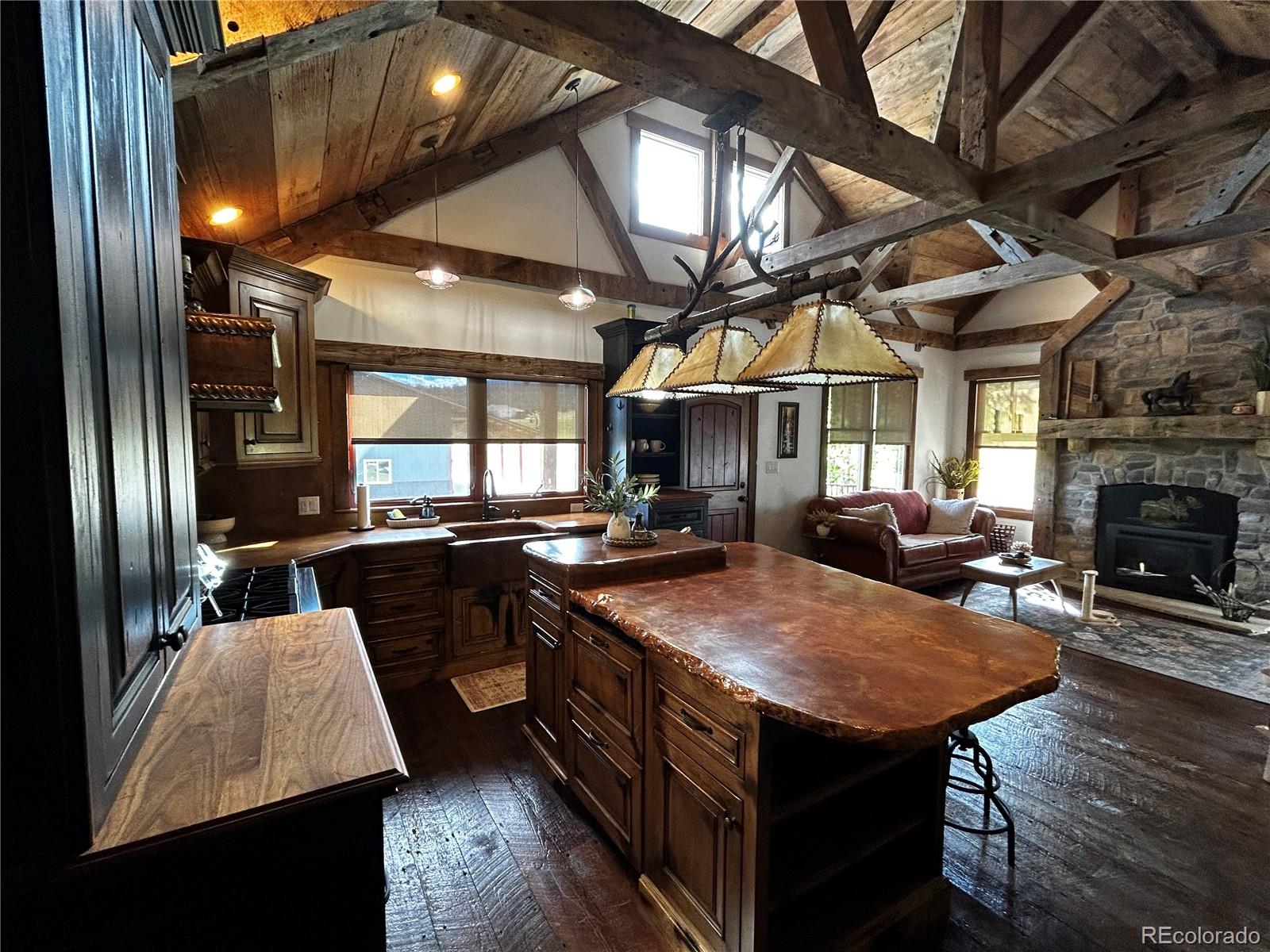 8238 Old San Isabel Road Rye, CO 81069 - Photo 7 of 31 a kitchen with stainless steel appliances granite countertop a sink a stove and a wooden floors