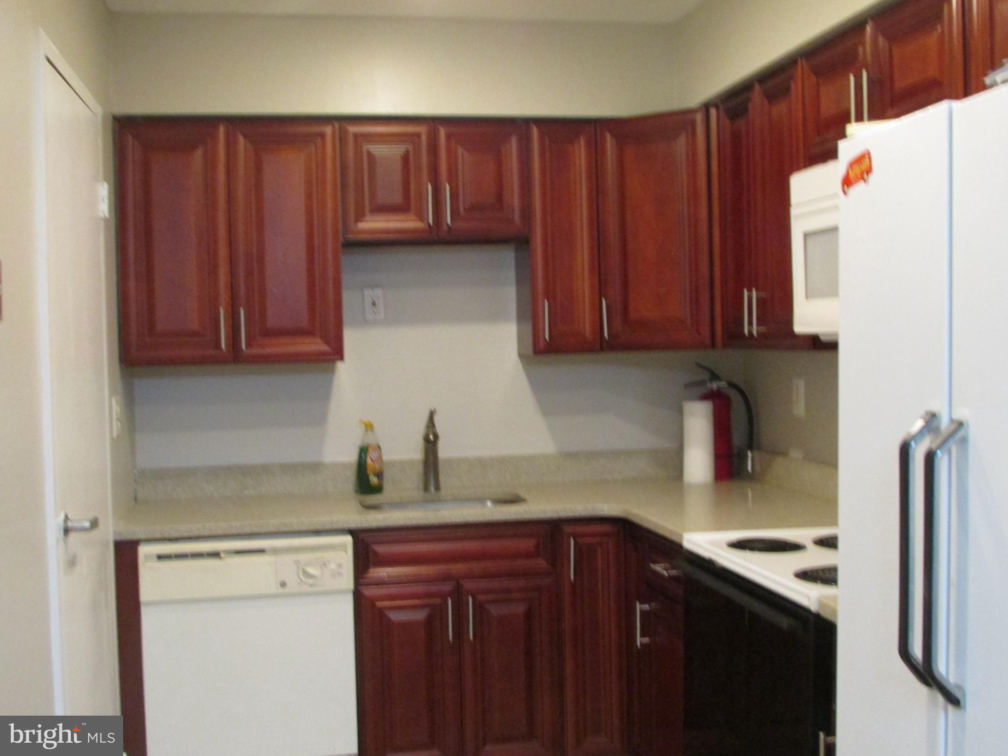 1027 Harbour Drive Palmyra, NJ 08065 - Photo 3 of 16 a kitchen with a sink a refrigerator and cabinets