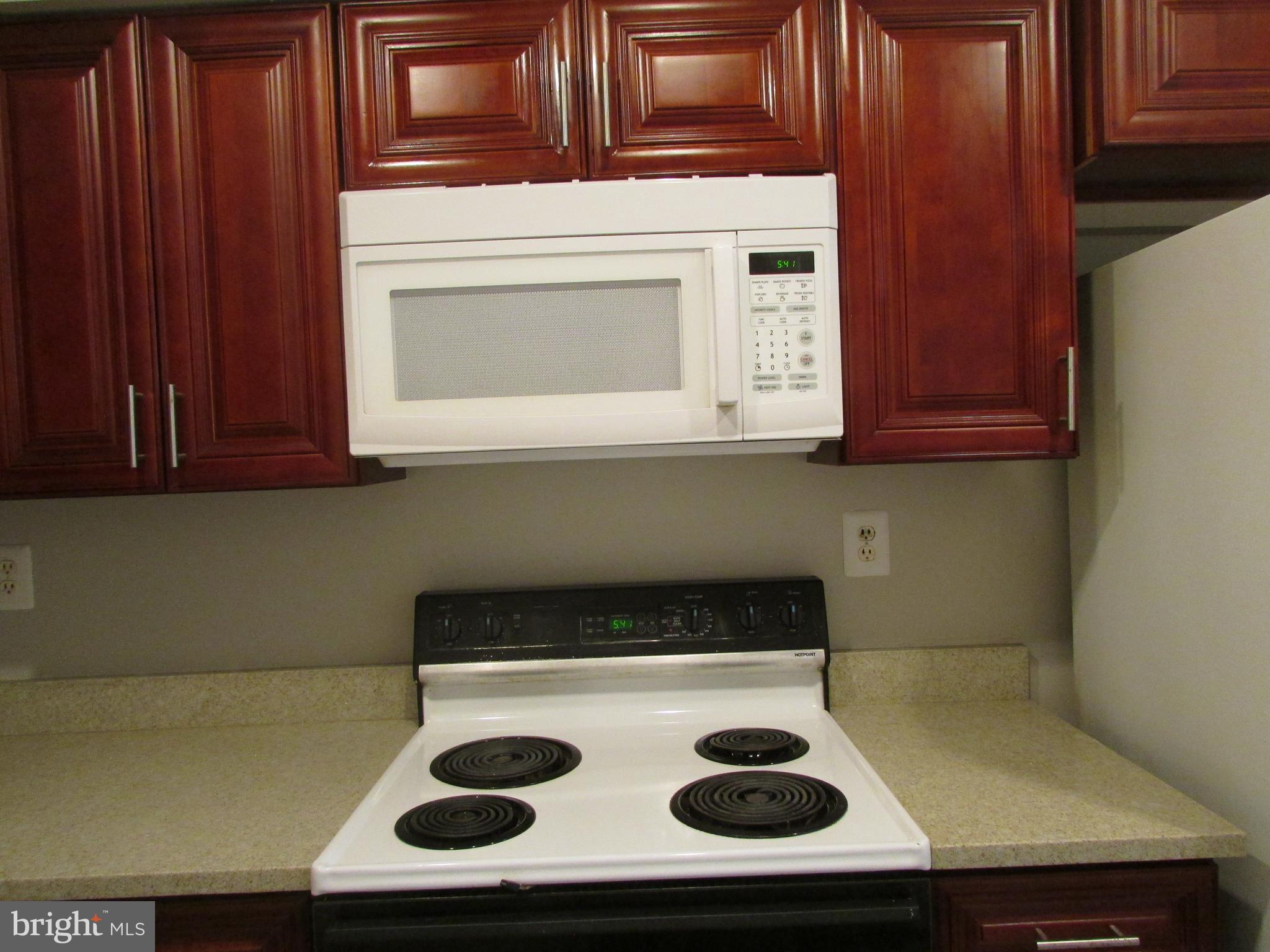 1027 Harbour Drive Palmyra, NJ 08065 - Photo 4 of 16 a kitchen with a stove and a microwave