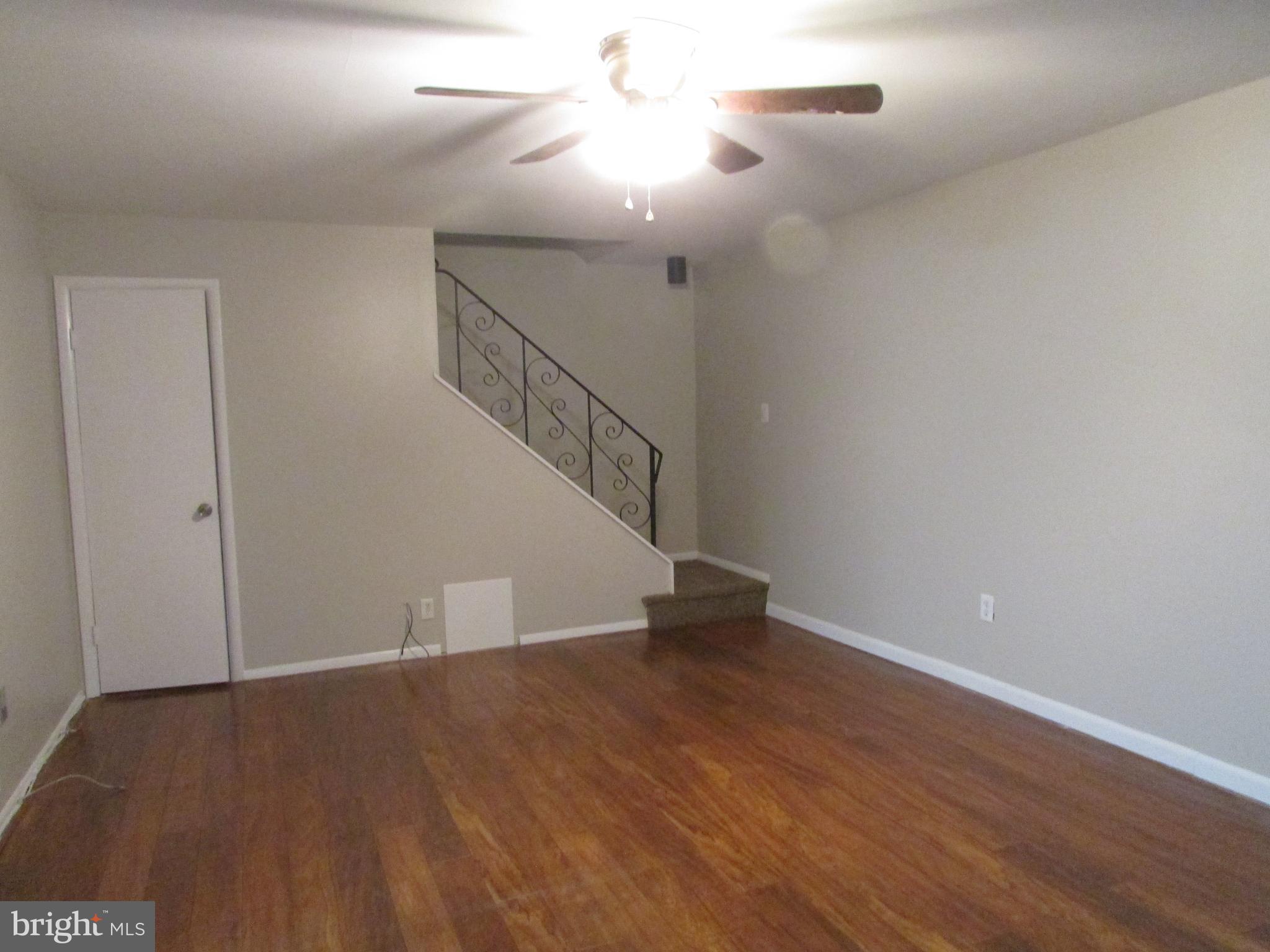 1027 Harbour Drive Palmyra, NJ 08065 - Photo 5 of 16 a view of an empty room with wooden floor and stairs