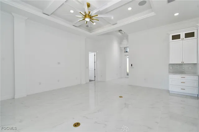 an empty room with a ceiling fan and chandelier fan