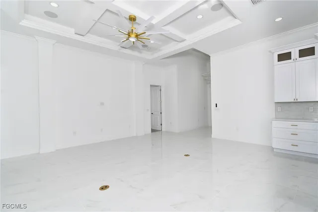 a view of an empty room with window and cabinet