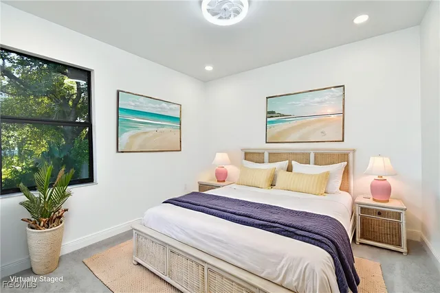 a view of an empty room with wooden floor and windows
