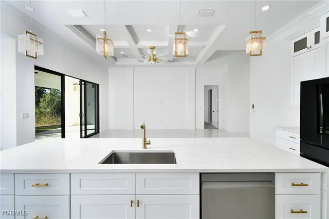 a kitchen with stainless steel appliances granite countertop white cabinets and a stove