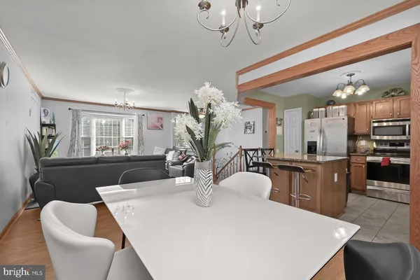 a view of a dining room with furniture and a chandelier