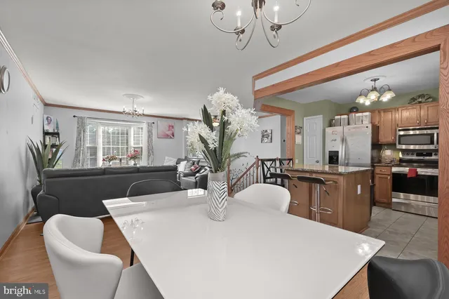 a view of a dining room with furniture and a chandelier