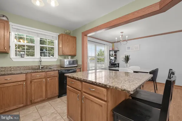 a kitchen with granite countertop sink stove and table