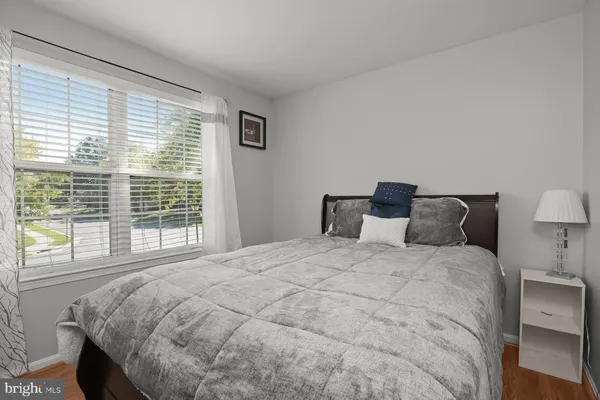 a large bed sitting in a bedroom next to a window