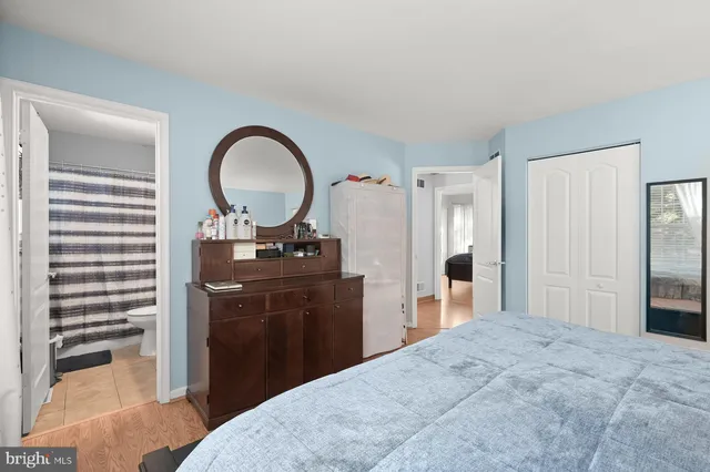 a bedroom with a bed and a dresser