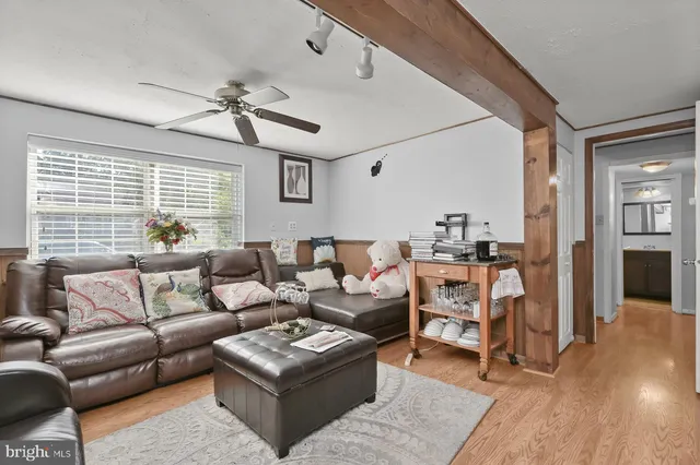 a living room with furniture and wooden floor