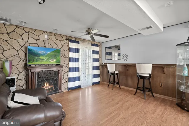 a living room with furniture and a fireplace